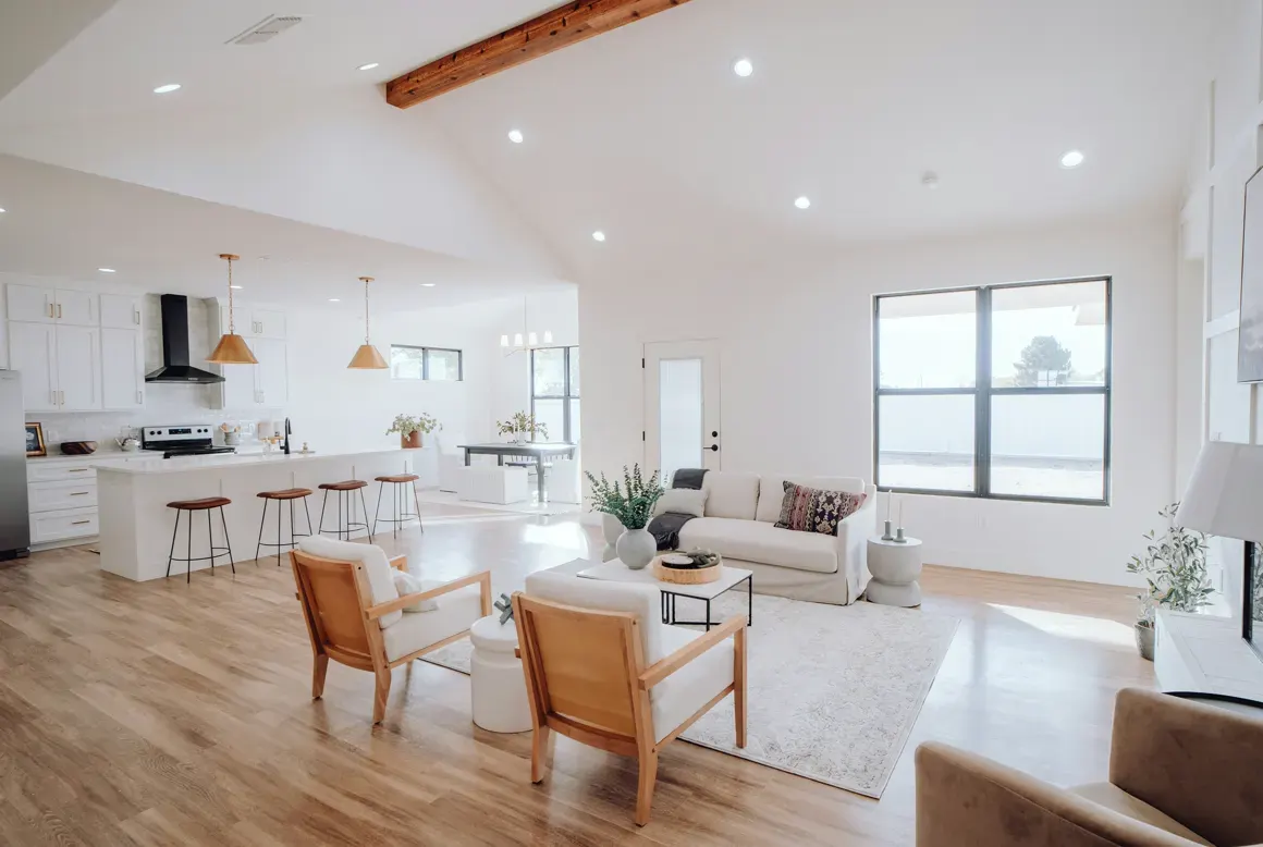 Open-plan interior lit by recessed LED cans and pendants